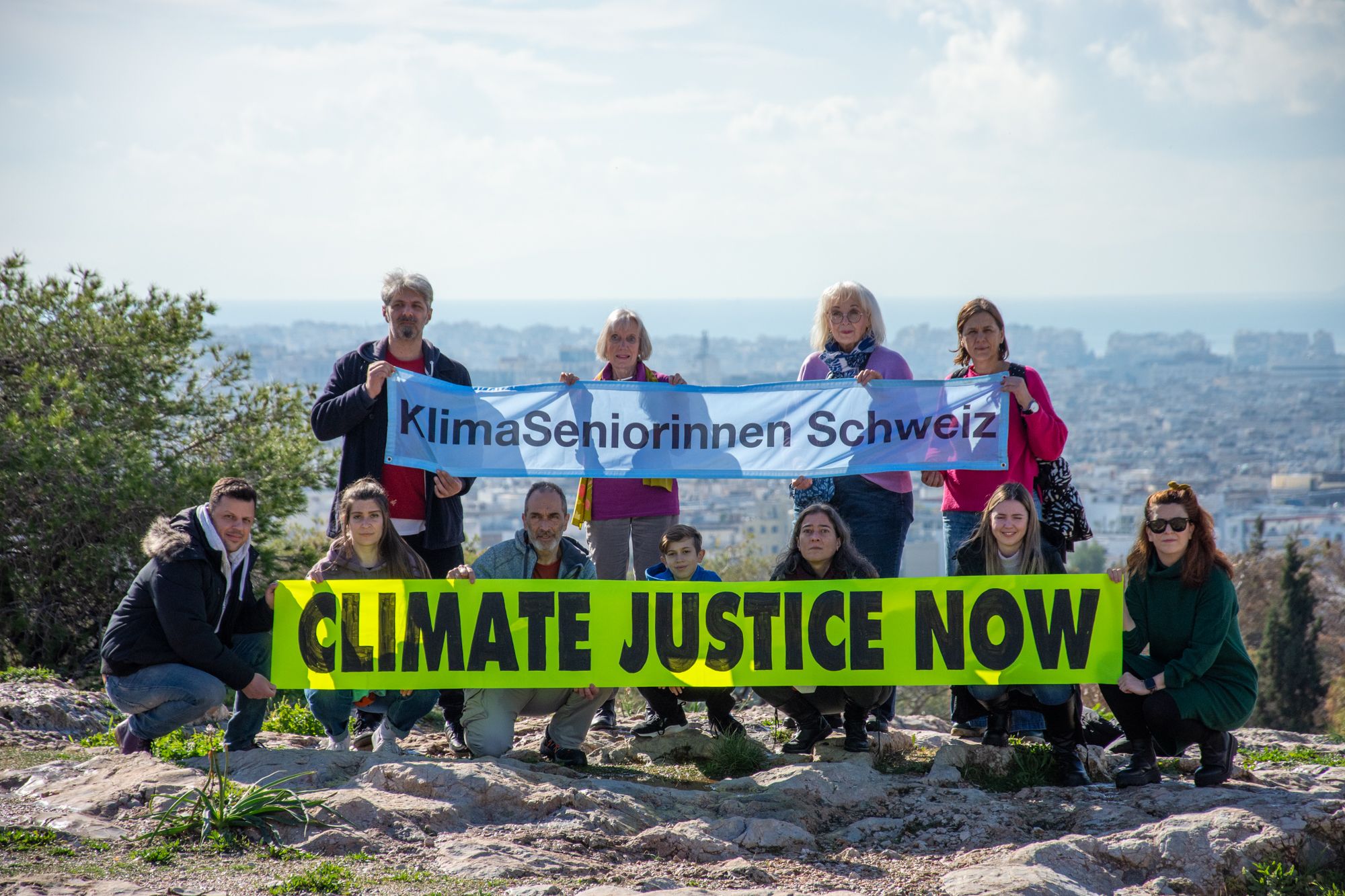 Greenpeace members holding a banner "Climate Justice Now"
